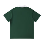 Norman Prince dark green cotton blend short sleeve polo shirt with white collar and sleeve trim.