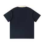 Norman Prince navy blue short sleeve polo shirt with contrasting cream collar and sleeve trim, cotton blend.