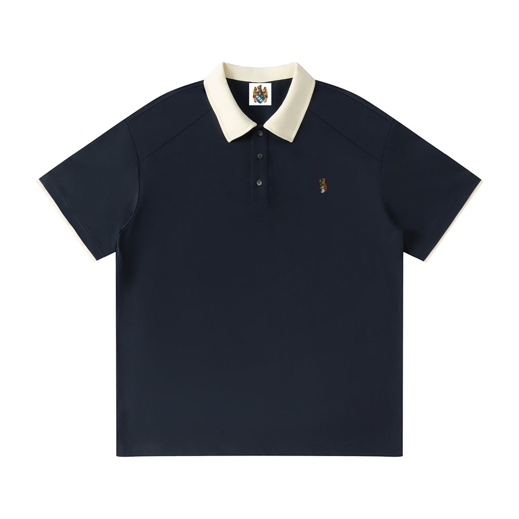 Norman Prince navy blue cotton blend short sleeve polo shirt with a contrasting cream collar and sleeve trim, featuring a small embroidered crest.
