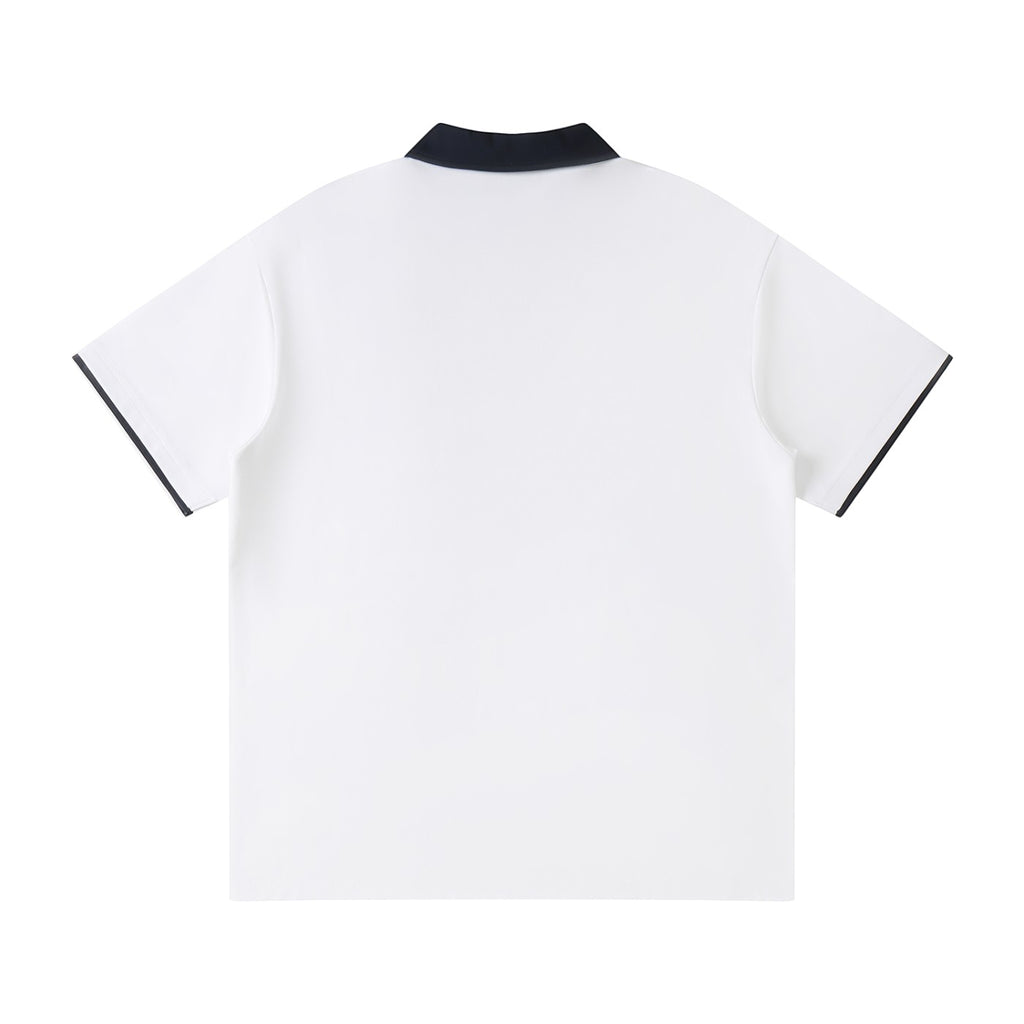Norman Prince white cotton blend short sleeve polo shirt with navy collar and sleeve trim.